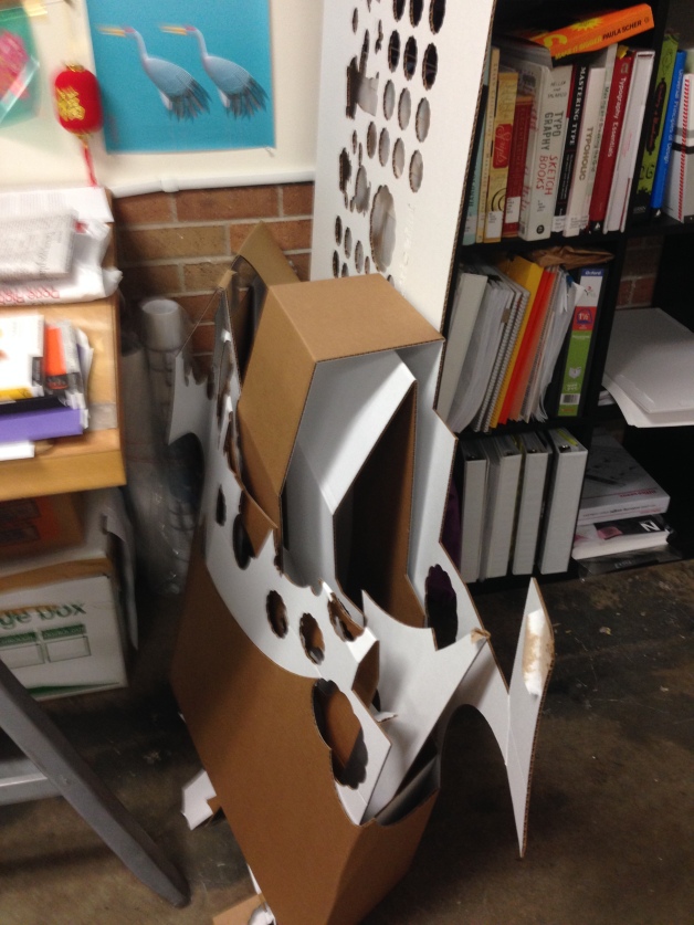 the remaining piece of cardboard showing the cutouts